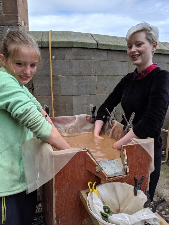 Two students with their hands in the flot tank.